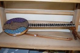 SMALL ETHNIC STRINGED INSTRUMENT WITH BOW DECORATED WITH BEADED DETAIL