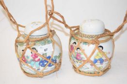 PAIR OF 20TH CENTURY GINGER JARS WITH WICKER SURROUND DISPLAYING ORIGINAL LABEL FOR HONG KONG