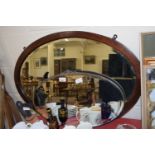 TWO OVAL BEVELLED WALL MIRRORS