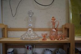 PINK GLASS SPIRIT DECANTER AND GLASSES PLUS A FURTHER FLAT BOTTOMED DECANTER