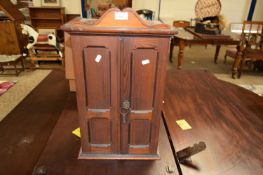 SMALL VICTORIAN STAINED PINE CABINET WITH TWO PANELLED DOORS OPENING TO AN INTERIOR WITH THREE SMALL