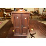 SMALL VICTORIAN STAINED PINE CABINET WITH TWO PANELLED DOORS OPENING TO AN INTERIOR WITH THREE SMALL