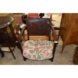 EARLY 20TH CENTURY OAK AND LEATHER BACKED LOW ARMCHAIR WITH GEORGE AND THE DRAGON DECORATION