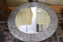 Arts & Crafts style circular bevelled wall mirror set in a pewter foil mounted frame decorated