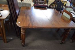 Large Victorian mahogany extending dining table with four additional leaves raised on fluted legs