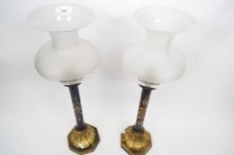 Pair of French bronze candle lamps, fitted with frosted glass shades, stems decorated with faux