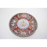 Chinese enamel plate, the centre decorated with a deity surrounded by peaches and floral design