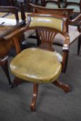 Late 19th/early 20th century mahogany framed and leather upholstered revolving desk chair on four