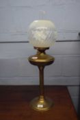Brass oil lamp with floral glass shade