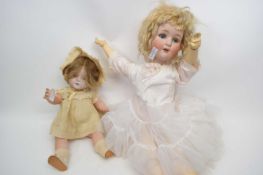 Two early 20th century dolls with bisque heads, larger doll bisque head marked S&H Germany