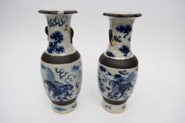Pair of Chinese porcelain crackle ware vases, the ground decorated in blue and white with dragons (