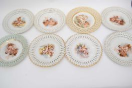 Quantity of Continental porcelain plates, all with printed designs of cherubs within pierced borders