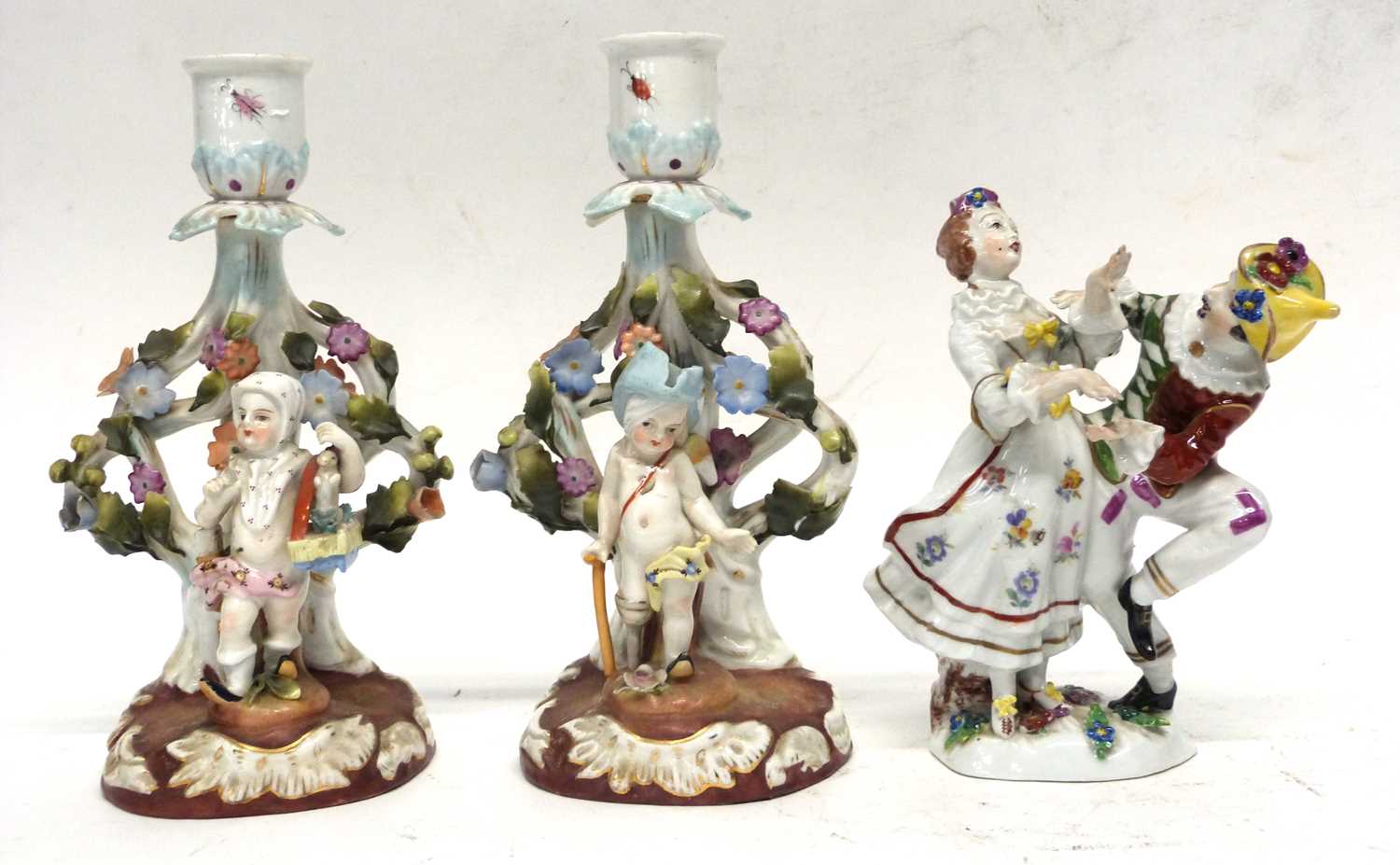 Pair of Continental porcelain candleholders and other Continental porcelain figures including a