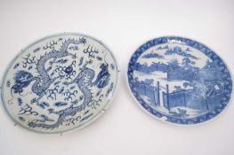 Two Oriental chargers, both with blue and white designs including one with dragons chasing the