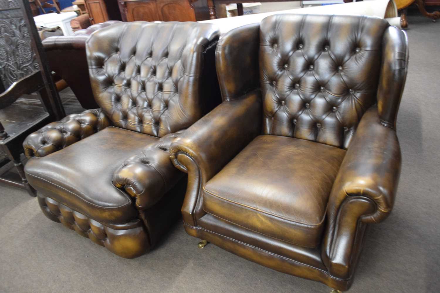 A Thomas Lloyd brown Chesterfield style leather armchair and another similar, 90cm wide
