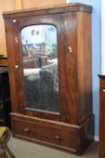 Victorian mahogany wardrobe with single door fitted with an arched mirror over a single drawer