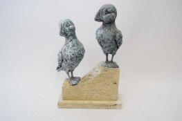 Terracotta model of two puffins perched on a rock