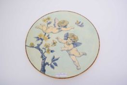 A Minton (Kensington Gore) charger decorated wth cherubs chasing butterflies34cm diameterrestoration