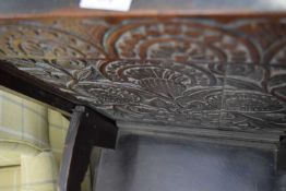 17th century and later oak monks bench or adaptable chair, the flip-over top with carved floral