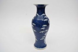 Chinese porcelain baluster vase decorated with prunus on a blue ground