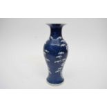 Chinese porcelain baluster vase decorated with prunus on a blue ground