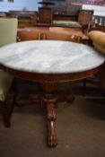 Georgian style pedestal table with circular marble top over a turned column and tripod base with paw