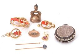 Mixed Lot: Victorian fob with a bloodstone monogrammed matrix, two stick pins, yellow metal disc
