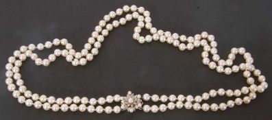 Double row of simulated pearls of uniform size to a 9ct white gold clasp, set with seed pearls and