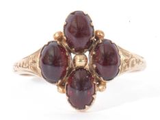 9ct gold and garnet set ring, the gold bead centre surrounded by four cabochon oval garnets, all