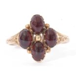 9ct gold and garnet set ring, the gold bead centre surrounded by four cabochon oval garnets, all