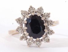 9ct gold sapphire and diamond cluster ring, the dark oval sapphire set within a small diamond