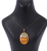 Oval agate pendant framed in a hallmarked 9ct gold mount, 45 x 30mm, suspended from a gilt metal