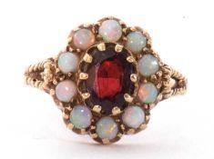 9ct gold garnet and opal cluster ring, the central garnet within a surround of 10 round cabochon