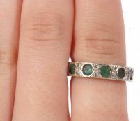 14ct gold emerald and diamond half eternity ring featuring six round cut emeralds, highlighted