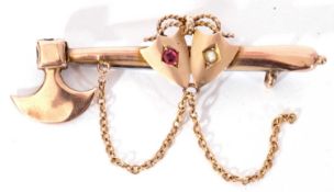 Antique 9ct gold axe and shield brooch, the shield set with a small ruby and small seed pearl,