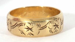 14ct gold stamped wedding ring, the band with a floral engraved design, 6.7gms, size R/S