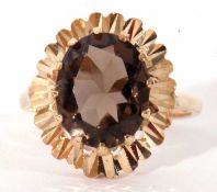 9ct gold smoky quartz dress ring, the oval faceted quartz multi-claw set and raised above a bright