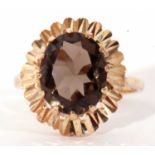 9ct gold smoky quartz dress ring, the oval faceted quartz multi-claw set and raised above a bright