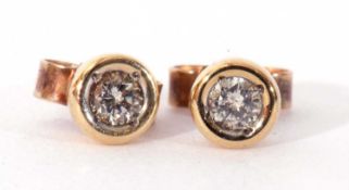 Pair of 9ct gold diamond stud earrings, the small brilliant cut diamonds bezel set to post fittings
