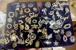 Large pad containing approx 70 costume brooches