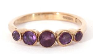 Modern 9ct gold amethyst five stone ring featuring five graduated round cut amethysts, all bezel