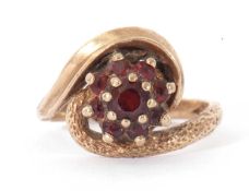 9ct gold garnet cluster ring, the graduated round faceted garnet cluster raised above polished and