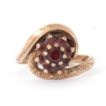 9ct gold garnet cluster ring, the graduated round faceted garnet cluster raised above polished and