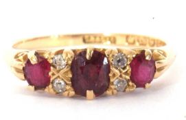 Victorian ruby and diamond ring featuring three graduated oval cushion cut rubies, highlighted