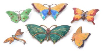 Group of enamel butterfly and dragonfly brooches to include four stamped silver examples and two