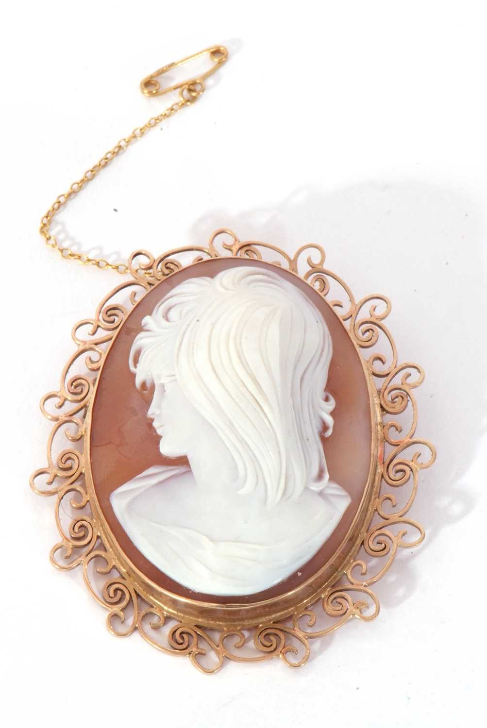 Large carved shell cameo depicting a head and shoulders profile of a lady, framed in an ornate