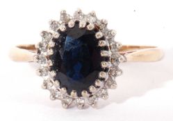 9ct gold sapphire and diamond cluster ring, the oval faceted dark sapphire multi-claw set within a