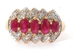 Modern 9ct gold ruby and diamond ring featuring a graduated central row of mixed cut rubies raised