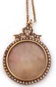 Antique circular locket, framed within a seed pearl and ribbon tied surround, the verso with a