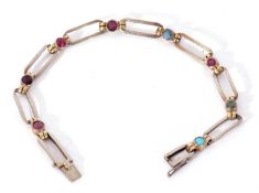 Precious metal and coloured stone bracelet featuring 8 open work rectangular links joined by various